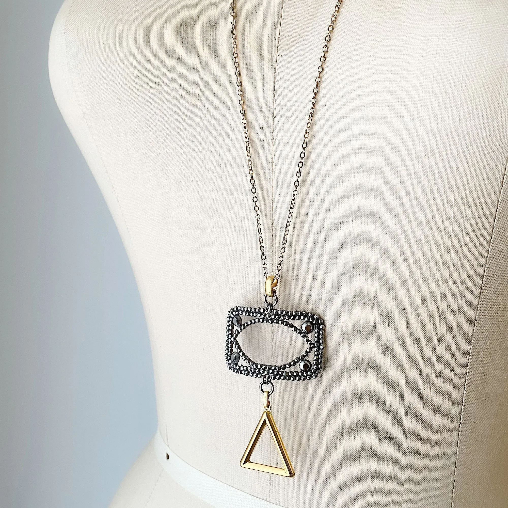 LAKOTA steel buckle and gold triangle necklace