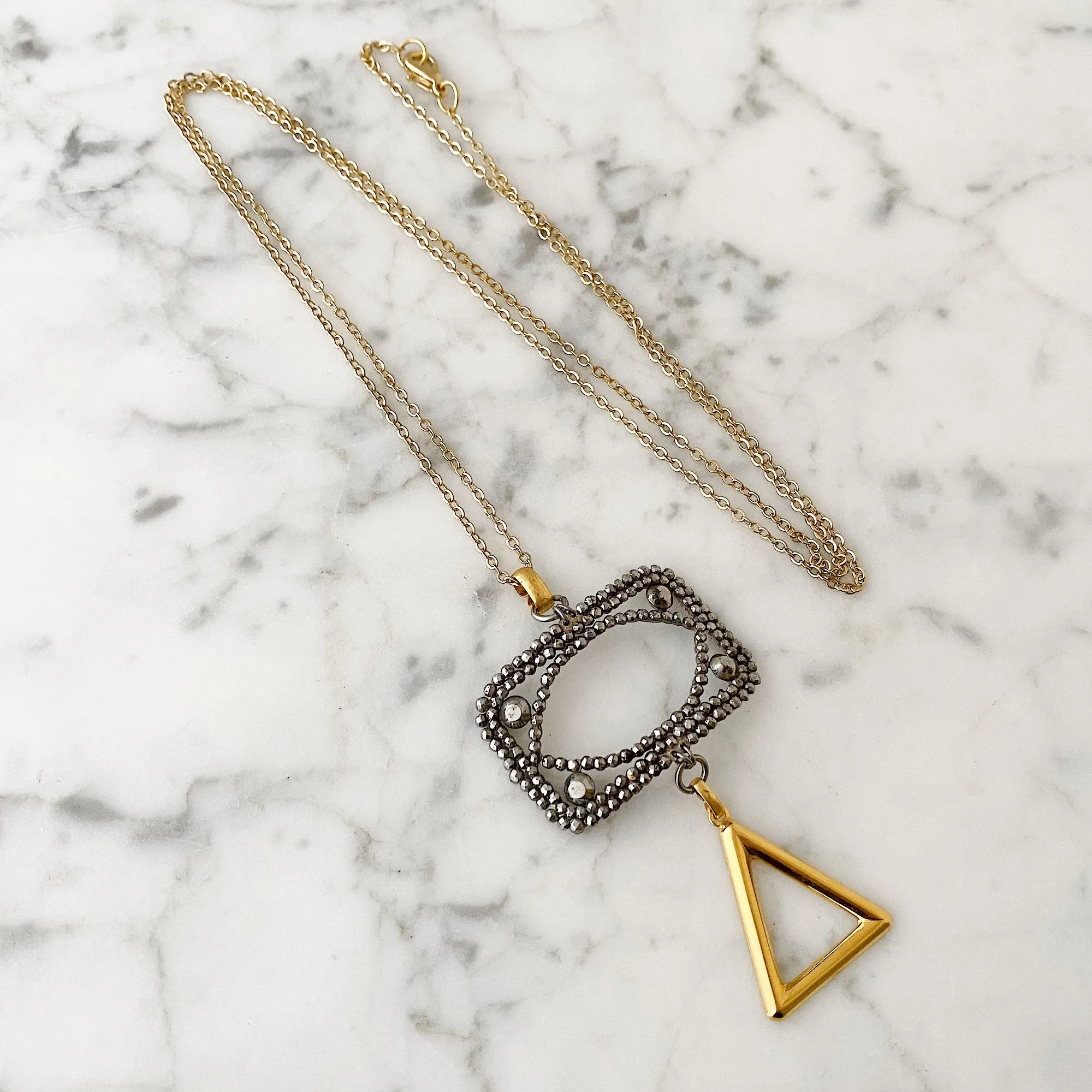 LAKOTA steel buckle and gold triangle necklace